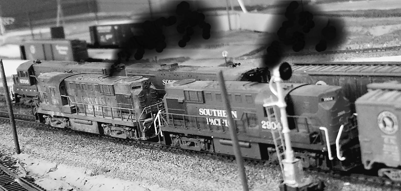 A PHOTO SHOPPED BLACK AND WHITE PHOTO OF TWO ALCO RS11 LOCOMOTIVES BELLOWING OUT THICK BLACK SMOKE ON MY N SCALE MODEL RAILROAD.