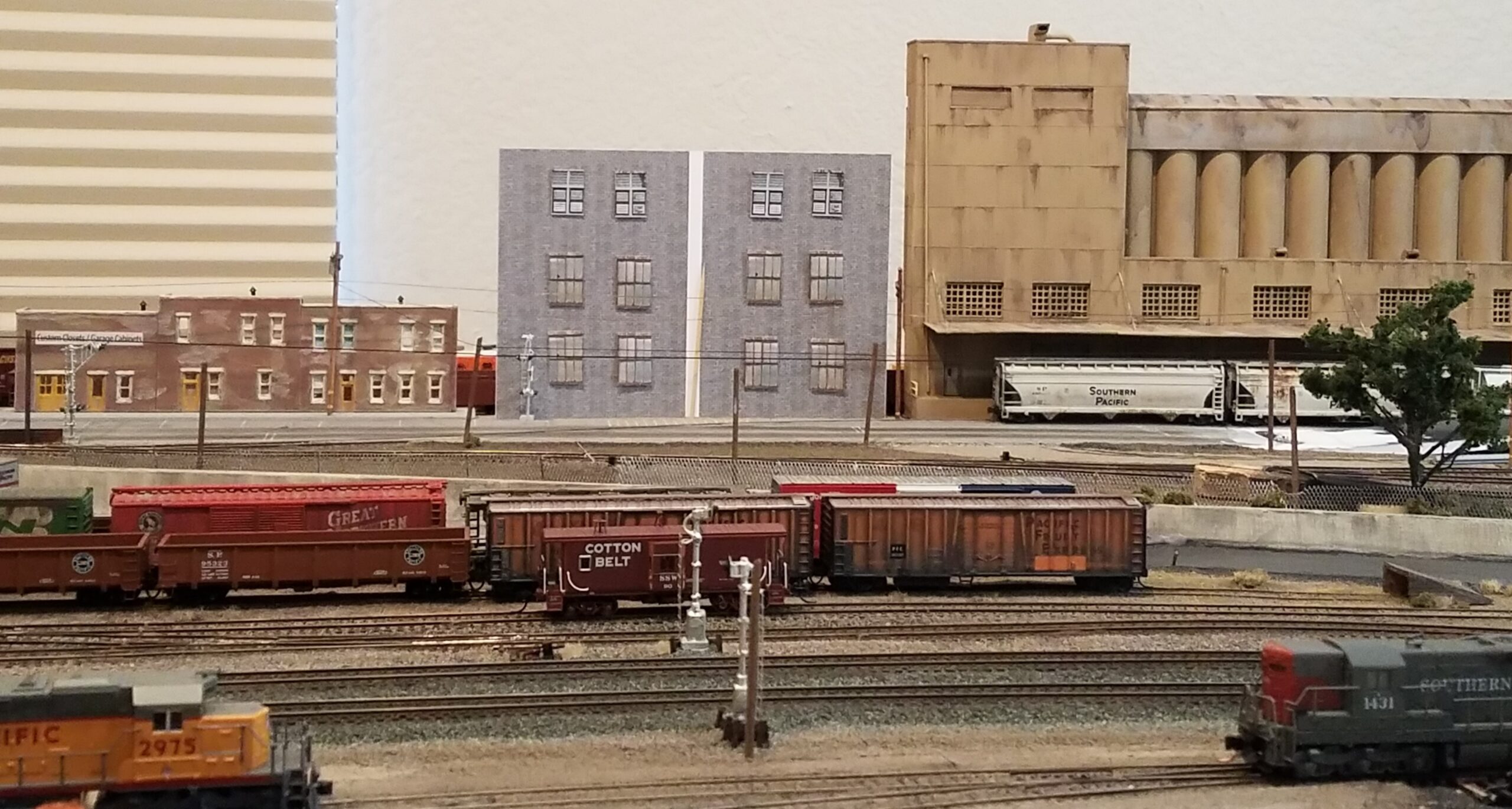 LOW RELIEF BACKGORUND FLATS ARE USED TO BLOCK THE VIEW OF THE STAGING TRACKS